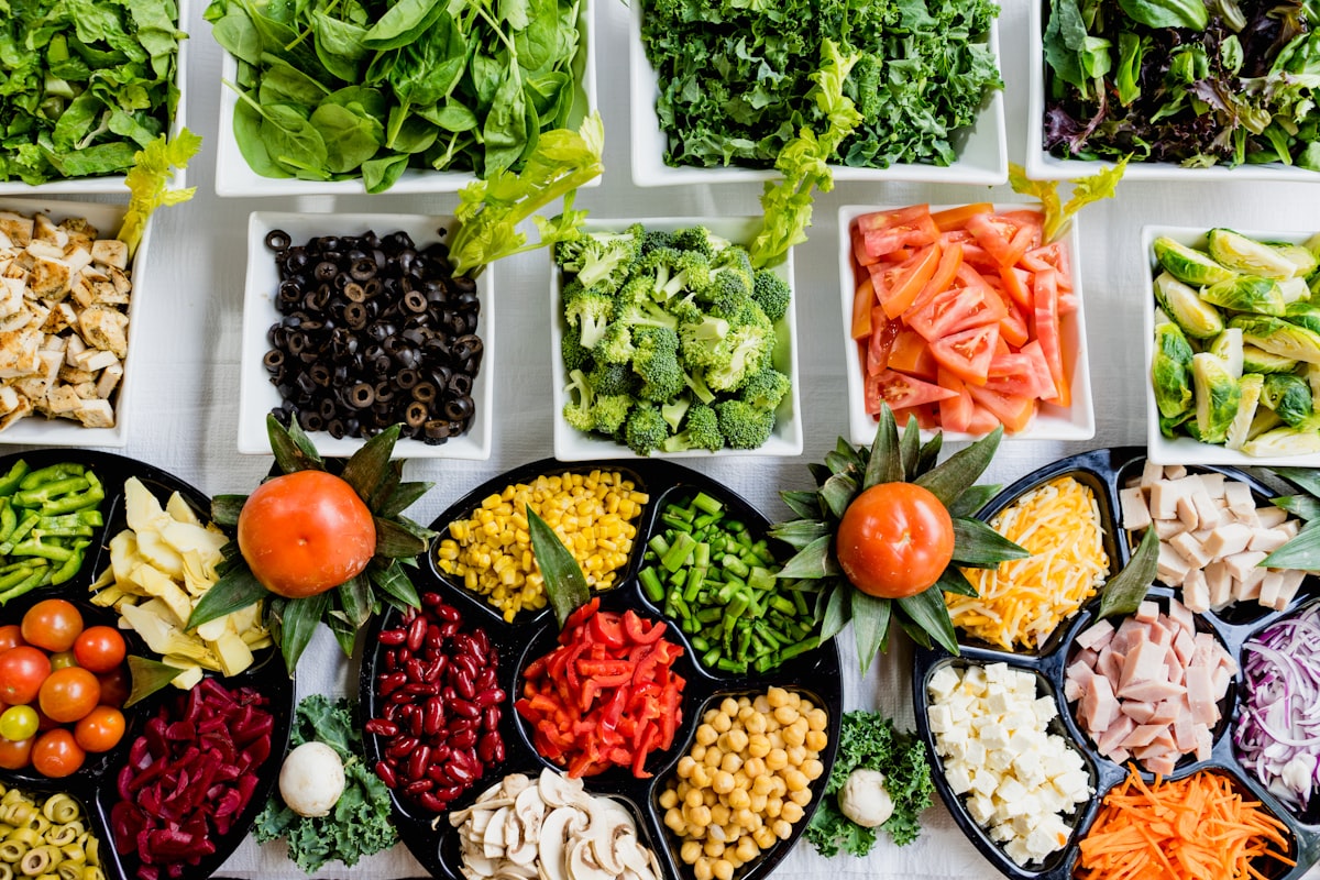Baked sweet potatoes topped with black beans, avocado, and salsa